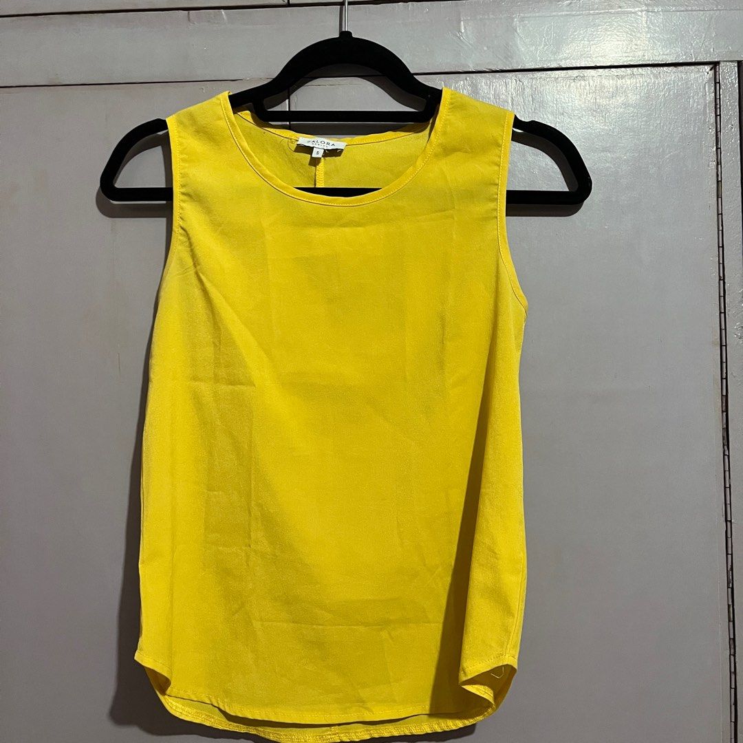 Zalora Basics Yellow Sleeveless Top (Category: Sleeveless) located in Pasig City. Submitted by ajdlsrysx (Listing ID 1413197910, Image 1). Description: - Brand: Zalora Basics - Style: Sleeveless top - Color: Bright yellow - Size: Small - Neckline: Round - Design: Classic, simple - Features: Lightweight fabric, suitable for warm weather - Details: Vertical seam at the back - Perfect for: Casual, everyday wear.