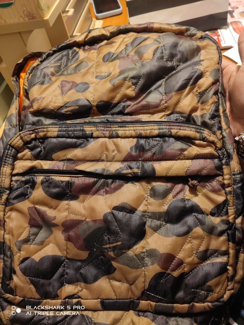 A Bathing Ape Camo Backpack (Category: Backpacks) located in Mandaluyong City. Submitted by human_crates (Listing ID 1416744160, Image 1). Description: - off / Legit A Bathing Ape backpack - Unique camo pattern - Front zip pocket - Padded shoulder straps for comfort - Orange interior lining - A Bathing Ape logo tag - Padded back straps.