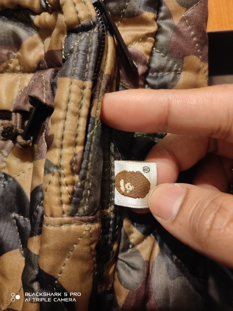 A Bathing Ape Camo Backpack (Category: Backpacks) located in Mandaluyong City. Submitted by human_crates (Listing ID 1416744160, Image 3). Description: - off / Legit A Bathing Ape backpack - Unique camo pattern - Front zip pocket - Padded shoulder straps for comfort - Orange interior lining - A Bathing Ape logo tag - Padded back straps.