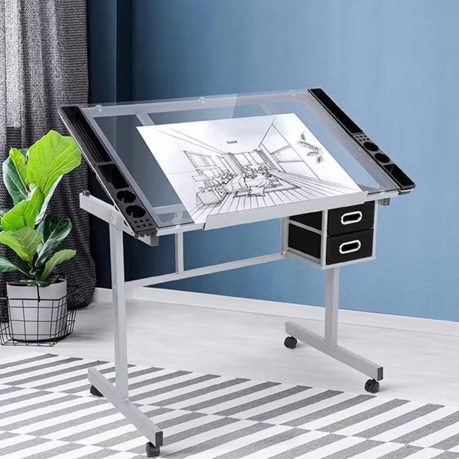 Adjustable Drafting Table / Drawing Desk with Drawers (Tempered Glass) (Category: Tables & Sets) located in Batangas. Submitted by adadriann (Listing ID 1416760789, Image 2). Description: Adjustable drafting table with tempered glass top. Used for 3 years during engineering studies and well maintained. No visible damage; fully functional (angle adjustment, drawers, wheels). Features: • Adjustable angle (0–60°) • Tempered glass tabletop • Steel fr