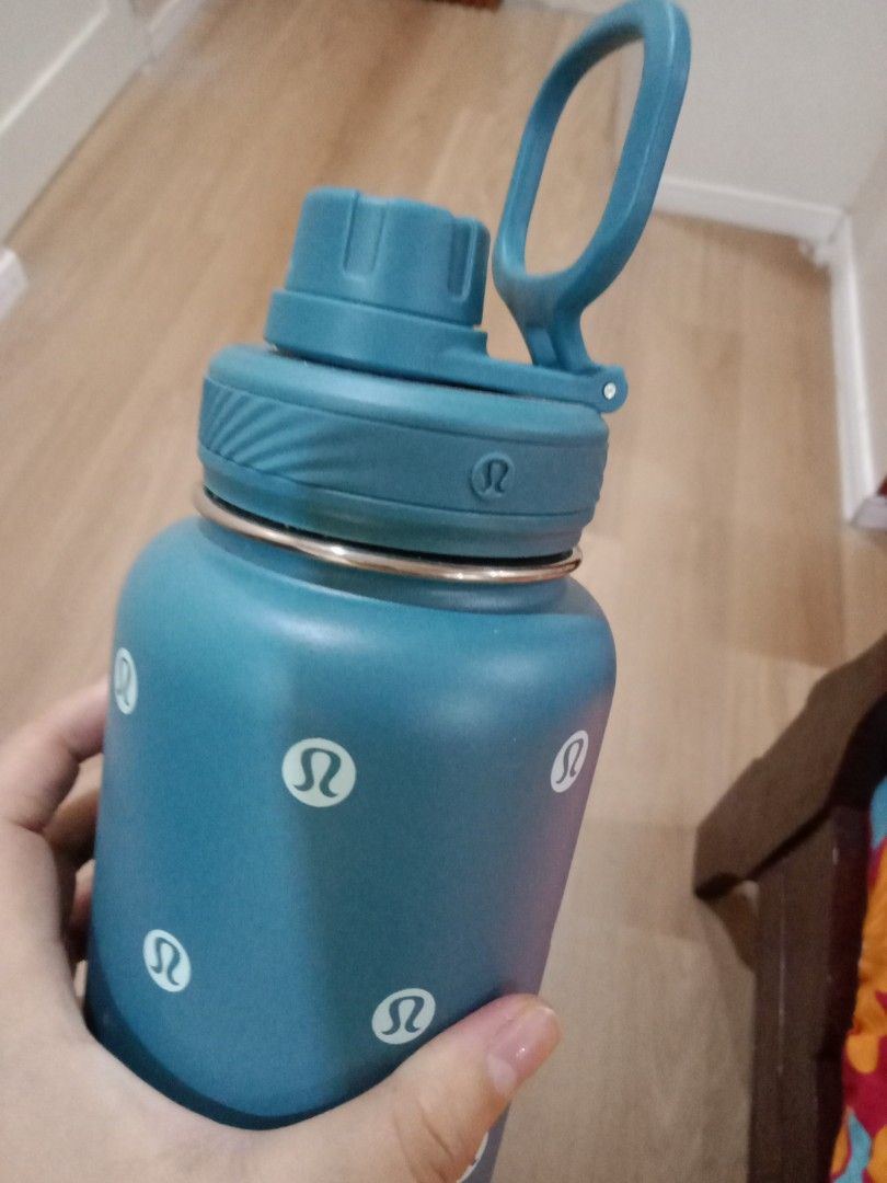 AquaFlask Lululemon Water Bottle (Category: Water Bottles & Tumblers) located in Cebu City. Submitted by monsterheart (Listing ID 1416753847, Image 3). Description: - AquaFlask water bottle - Features Lululemon logo - Teal body with white Lululemon logos - Dark blue base - Teal handle - Flip-top lid - AquaFlask logo on base - Insulated.