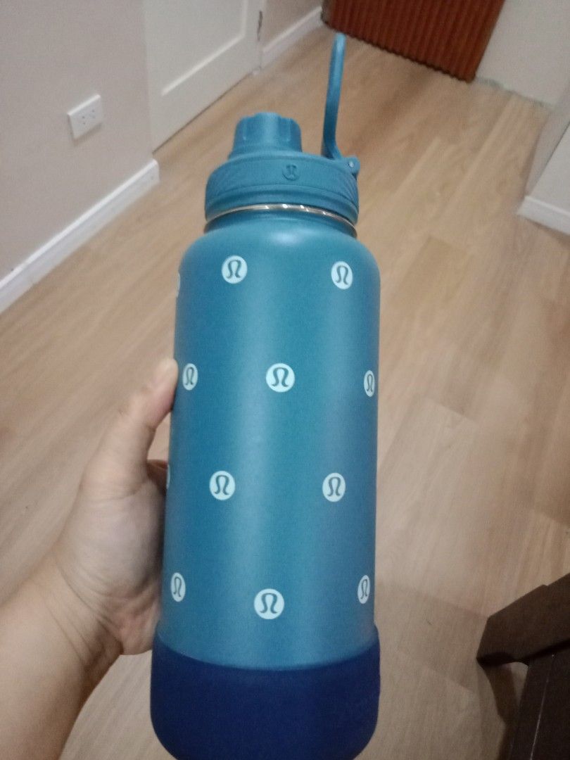 AquaFlask Lululemon Water Bottle (Category: Water Bottles & Tumblers) located in Cebu City. Submitted by monsterheart (Listing ID 1416753847, Image 1). Description: - AquaFlask water bottle - Features Lululemon logo - Teal body with white Lululemon logos - Dark blue base - Teal handle - Flip-top lid - AquaFlask logo on base - Insulated.
