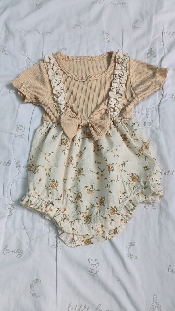Baby Floral Romper with Bow (Category: Babies & Kids Fashion) located in Quezon City. Submitted by _itsmemarie_ (Listing ID 1416659933, Image 1). Description: - Adorable baby romper - Beige ribbed top with floral print bottom - Cute bow detail - Ruffled accents on straps and bottom - Made from soft, comfortable fabric - Ideal for everyday wear or special occasions.