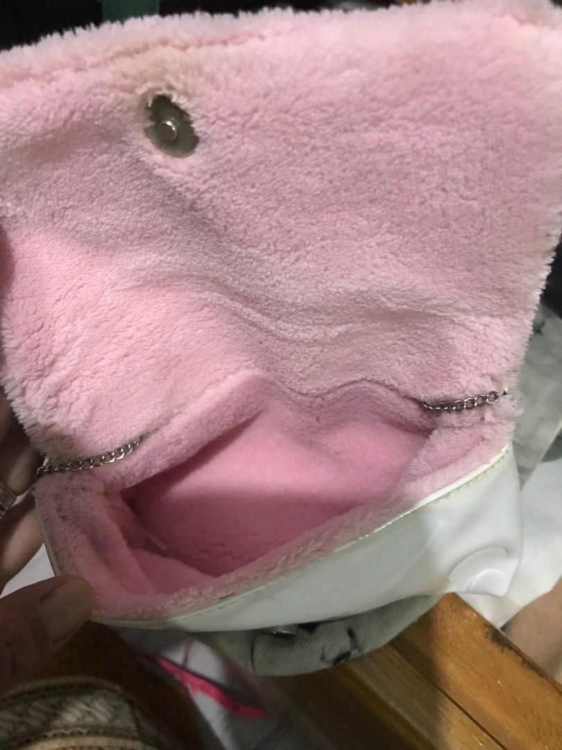 Chanel White Pink Chain mini Bag (Category: Luxury Bags & Wallets) located in Caloocan City. Submitted by mermaid.drive (Listing ID 1416802252, Image 3). Description: - Pink accents - Pink fuzzy interior - Chain strap - Magnetic snap closure - Chanel logo visible - Approximate dimensions: 6" length x 4" height.