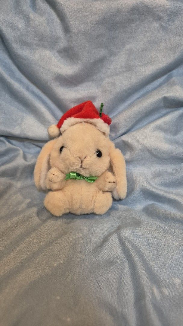 Amuse Christmas Loopy Bunny Plush Charm (Category: Plushies & Soft Toys) located in Quezon City. Submitted by camillechua0221 (Listing ID 1416646391, Image 1). Description: Adorable Loopy bunny wearing a Santa hat and a green ribbon. It has a small tag attached. The bunny is beige in color. It is a cute and festive item, perfect for Christmas decorations or as a gift..