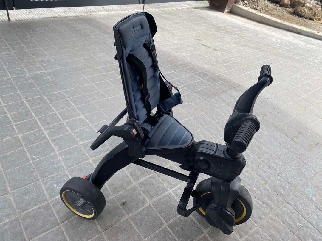 Doona Liki Trike S3 (Category: Strollers) located in Valenzuela. Submitted by khriska (Listing ID 1416680191, Image 1). Description: - Doona Liki Trike S3 - Stylish and compact design - Comfortable seat with safety harness - Foldable for easy storage and transport - Black wheels with yellow accents - Brand logo visible - Issues: 1. Back rest can no longer be folded. Needs a change in spring I guess since it's rusty na. 2. Himulmol on the backrest