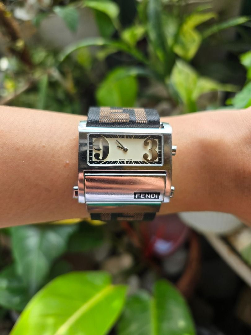 Fendi Zip Code (Category: Luxury Watches) located in Manila. Submitted by timearcph (Listing ID 1416779139, Image 2). Description: The watch in the image is a Fendi Zip Code model, also known by the reference numbers 1120G or 1120L, depending on the size. This Swiss-made timepiece is characterized by its distinctive cream or white dial with oversized Arabic numerals at the 3 and 9 o'clock positions. Watch Details Brand: Fendi Model: Zip Code (or 