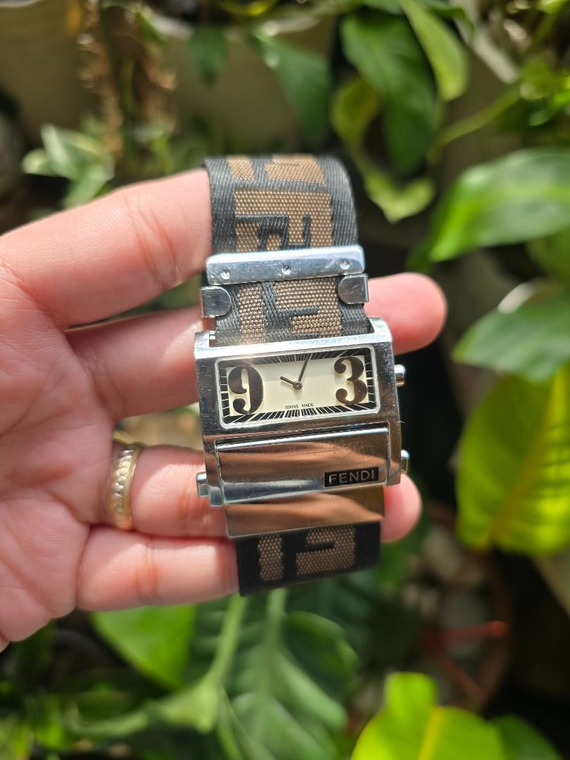 Fendi Zip Code (Category: Luxury Watches) located in Manila. Submitted by timearcph (Listing ID 1416779139, Image 3). Description: The watch in the image is a Fendi Zip Code model, also known by the reference numbers 1120G or 1120L, depending on the size. This Swiss-made timepiece is characterized by its distinctive cream or white dial with oversized Arabic numerals at the 3 and 9 o'clock positions. Watch Details Brand: Fendi Model: Zip Code (or 