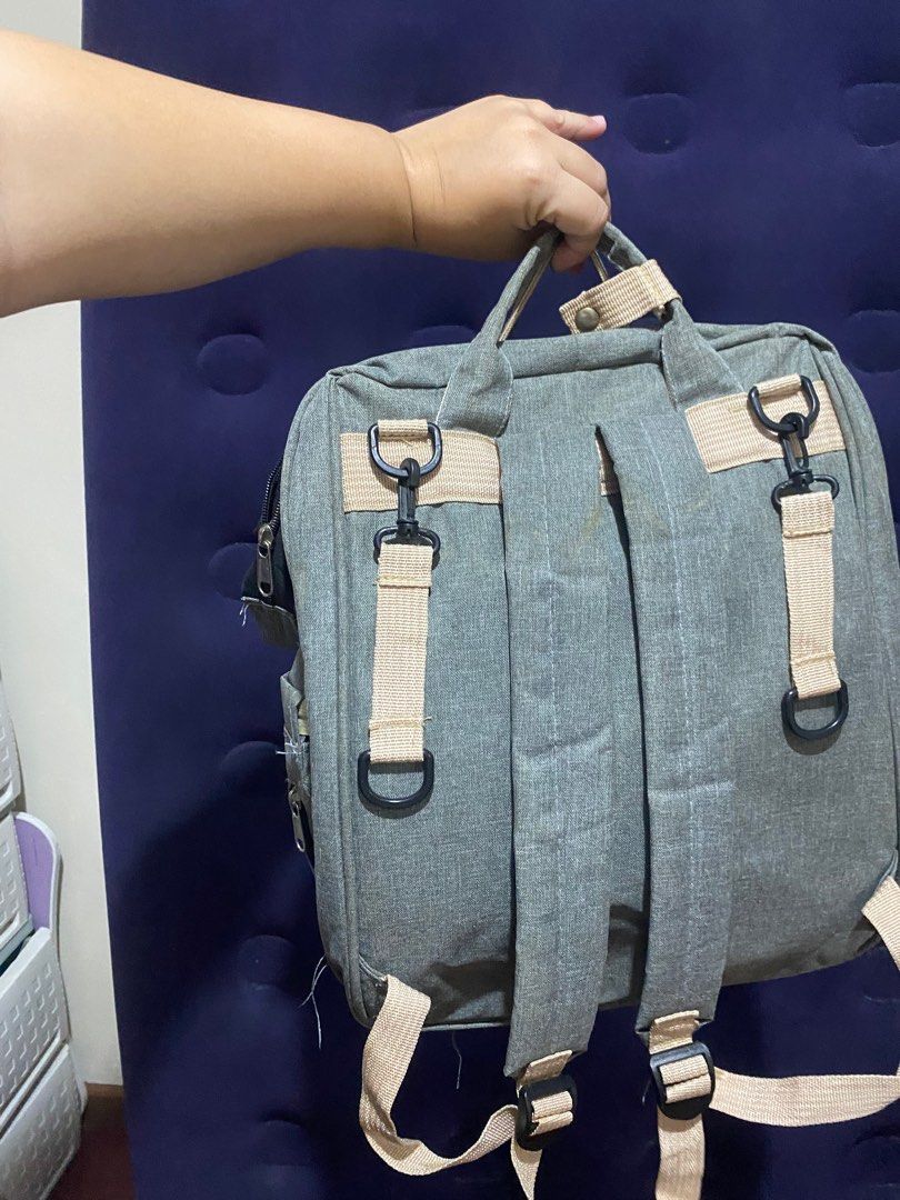 Grey Baby Bag (Category: Diaper Bags & Wetbags) located in Binan City. Submitted by lagunaxpreloved (Listing ID 1416643790, Image 3). Description: - Grey diaper backpack - Multiple compartments and pockets for organization - Top handle and adjustable straps - Front and side pockets - Stroller straps on the back - Features a "YOU ARE MY SUNSHINE" label.
