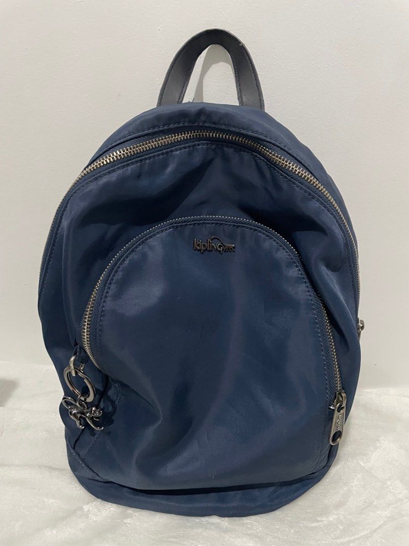 Kipling Navy Blue Backpack (Category: Backpacks) located in Manila. Submitted by reloom (Listing ID 1416760150, Image 1). Description: - Navy blue Kipling backpack - Main compartment with zipper closure - Front pocket with zipper closure - back pocket with zipper closure - Top handle - Includes Kipling monkey keychain - Straps show some wear (see picture) - Perfect for everyday use.