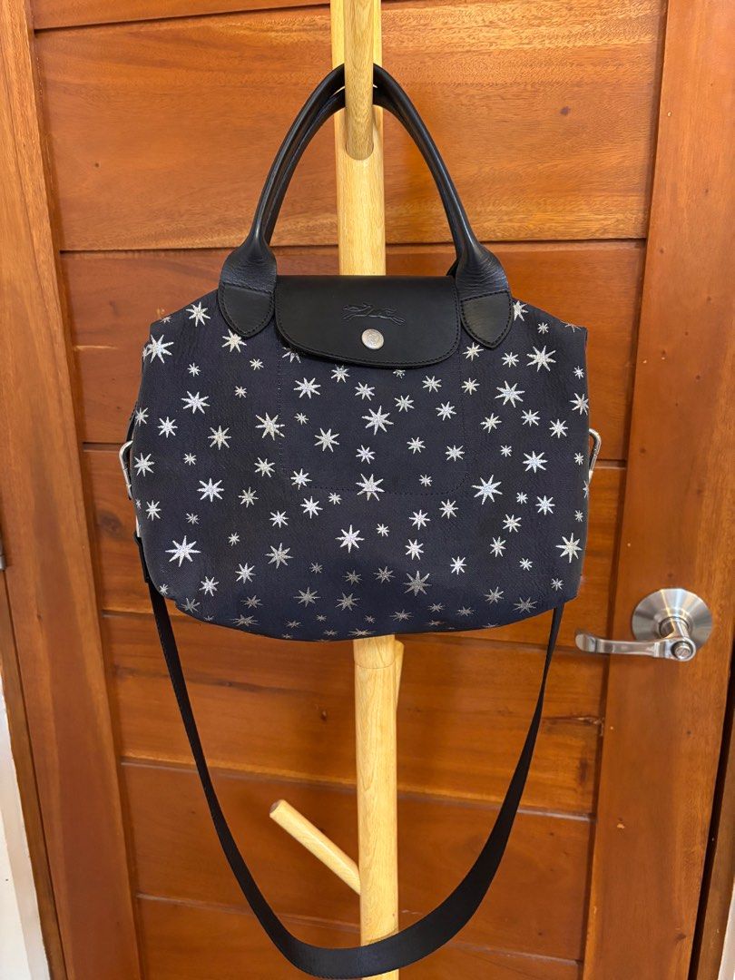 Longchamp Le Pliage Etoiles Top-Handle Bag S (Category: Luxury Bags & Wallets) located in Quezon City. Submitted by onlinebazaare (Listing ID 1416816351, Image 1). Description: - Longchamp Le Pliage Etoiles Top-Handle Bag S -bought directly from Rustans on sale for 12k - Navy blue fabric with star pattern - Black leather handles and flap - Detachable shoulder strap - Silver-toned hardware - Zipper closure - Matching fabric lining.