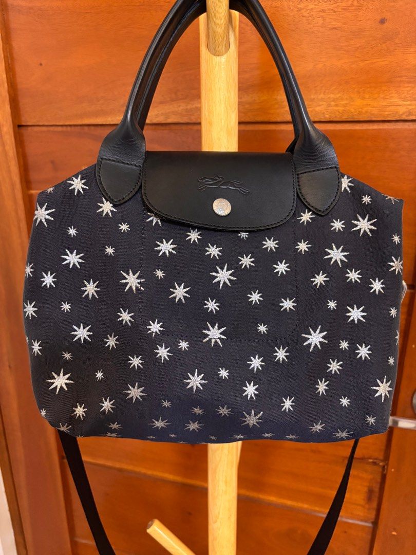 Longchamp Le Pliage Etoiles Top-Handle Bag S (Category: Luxury Bags & Wallets) located in Quezon City. Submitted by onlinebazaare (Listing ID 1416816351, Image 2). Description: - Longchamp Le Pliage Etoiles Top-Handle Bag S -bought directly from Rustans on sale for 12k - Navy blue fabric with star pattern - Black leather handles and flap - Detachable shoulder strap - Silver-toned hardware - Zipper closure - Matching fabric lining.