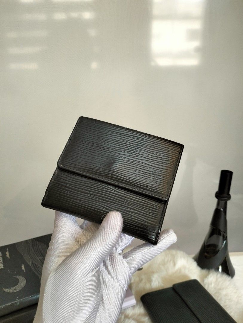 LV Epi Leather Wallet Compact (Category: Luxury Bags & Wallets) located in Manila. Submitted by alayassulittipidfinds (Listing ID 1416651003, Image 1). Description: Material: Signature Louis Vuitton Epi leather, known for its distinctive textured, grained appearance. Color: Black. Design: A compact, folding design with a front flap closure. Vintage: Similar authentic vintage models have been identified as far back as 1992..