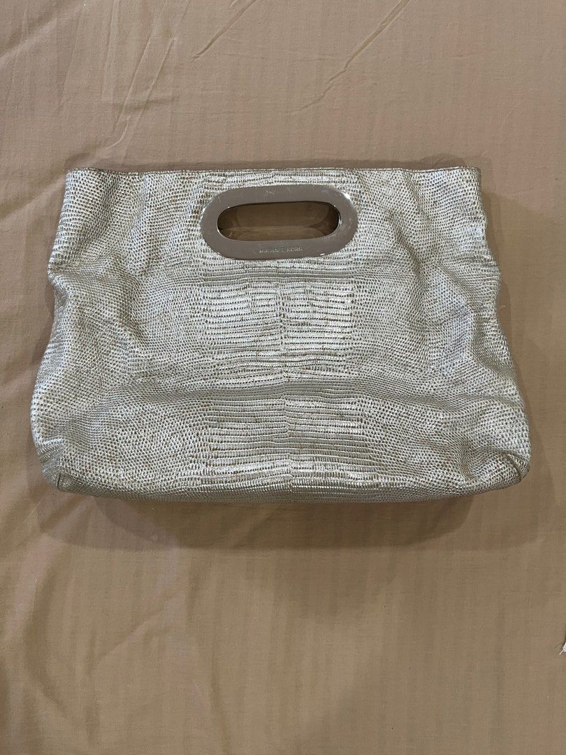 Michael Kors Metallic Berkley Clutch Bag (Category: Luxury Bags & Wallets) located in Cotabato. Submitted by nacreous (Listing ID 1416686549, Image 3). Description: Condition: 8/10 DESCRIPTION: ➤ Original pre-loved item ➤ Beautiful interior ➤ RFS: Decluttering FEATURES: Exterior ➤ Textured Leather ➤ Silver hardware ➤ Height: 11.5 in / 29.5 cm ➤ Height when folded: 7.5 in / 20 cm ➤ Width: 15.5 in / 39.5 cm ➤ Depth: 4 in / 10 cm Interior ➤ Two magn