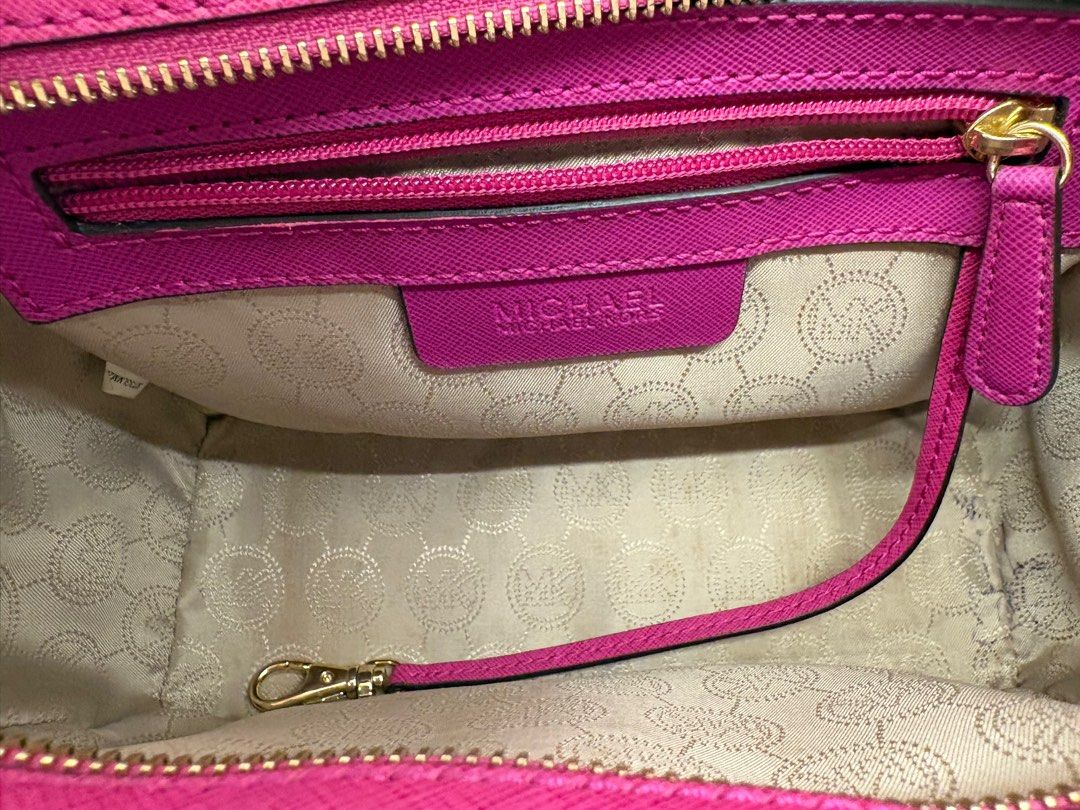 Michael Kors Selma Messenger Bag (Category: Luxury Bags & Wallets) located in Makati City. Submitted by harekrisha (Listing ID 1416668781, Image 2). Description: Pre-loved Michael Kors Selma messenger bag in fuchsia saffiano leather. Structured and sturdy, with a zip closure, interior compartments, and classic Michael Kors hardware and logo details. In good pre-loved condition with normal signs of use from regular wear. No major flaws and still v
