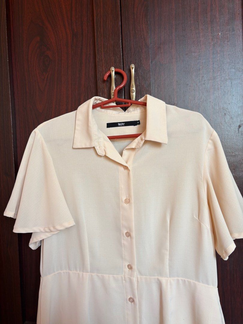 Mossimo Button-Down Dress (Category: Dresses) located in Quezon City. Submitted by didcluttered (Listing ID 1416689385, Image 2). Description: :payment first via gcash/maya/bank transfer :shipping via jnt :sf shouldered by buyer - Mossimo cream-colored dress - Size: M - Features a collared neckline - Button-down front - Short, flutter sleeves - Fitted waist - Slightly flared skirt.
