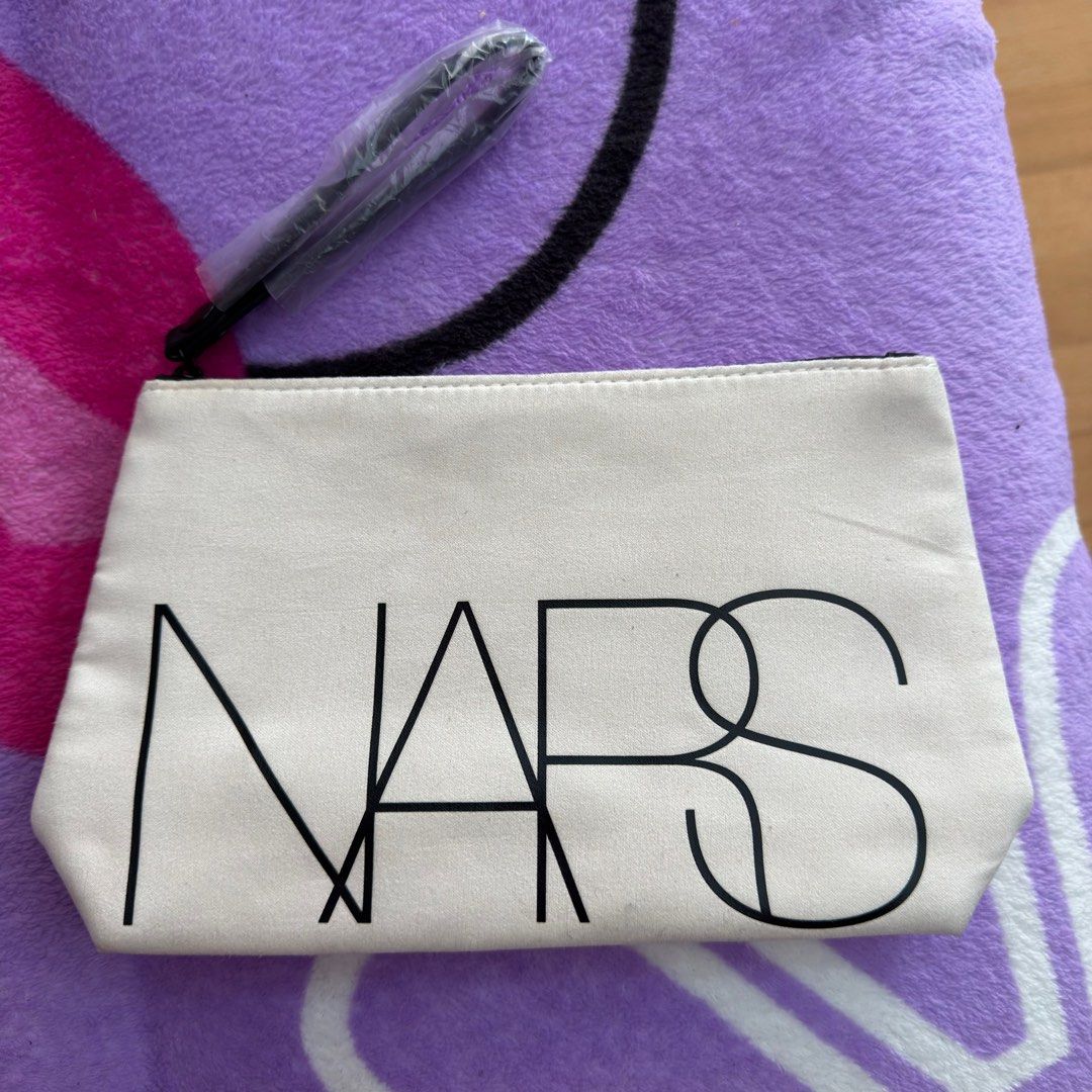 NARS Cosmetic Pouch (Category: Makeup) located in Makati City. Submitted by tinkerboy (Listing ID 1416677352, Image 1). Description: - Authentic NARS cosmetic pouch - Cream color with black NARS logo - Features a black zipper - Includes a makeup brush - Ideal size for storing makeup essentials.