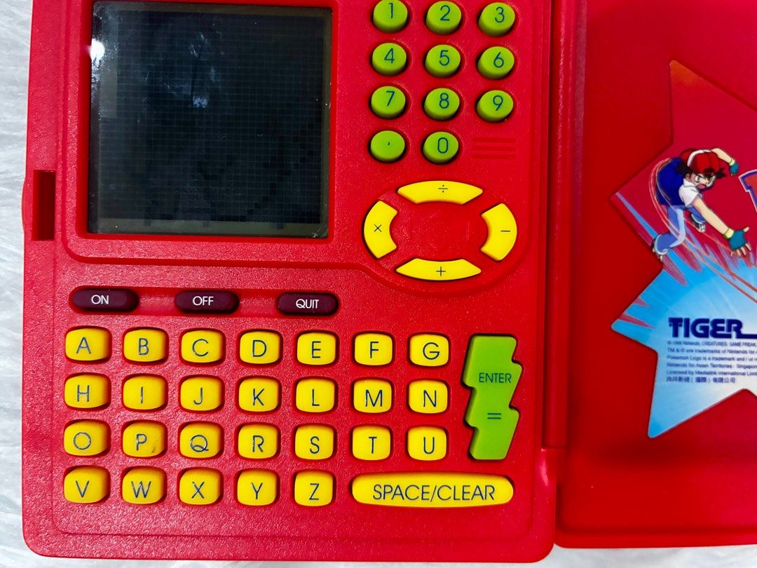 Preloved Original Pokemon Pokedex by Tiger (Category: Character Goods) located in Quezon City. Submitted by greatgoodies03 (Listing ID 1416745590, Image 2). Description: - Preloved Original Pokemon Pokedex by Tiger - Classic red design - Features the iconic Pokemon logo and characters - Fully functional screen and buttons - A great addition to any Pokemon collection - Perfect for fans of all ages ** ISSUE upper left side screen dead pixel see pho