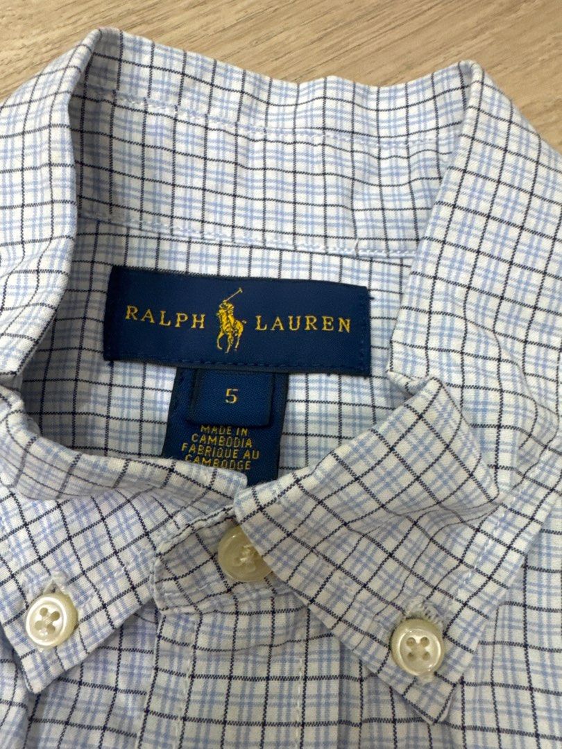 Ralph Lauren Checkered Shirt - Size 5 (Category: Babies & Kids Fashion) located in Quezon City. Submitted by starg888 (Listing ID 1416693522, Image 2). Description: - Ralph Lauren long-sleeved shirt - Blue and white checkered pattern - Button-down collar - Features the brand's logo on the chest - Made in Cambodia - Size 5 - Shoulder width: 12 inches - Length from shoulder to hem: 21 inches Used once for photoshoot.