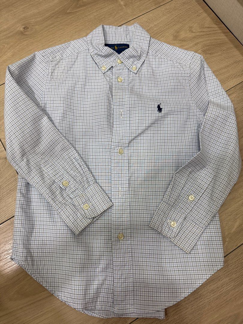 Ralph Lauren Checkered Shirt - Size 5 (Category: Babies & Kids Fashion) located in Quezon City. Submitted by starg888 (Listing ID 1416693522, Image 1). Description: - Ralph Lauren long-sleeved shirt - Blue and white checkered pattern - Button-down collar - Features the brand's logo on the chest - Made in Cambodia - Size 5 - Shoulder width: 12 inches - Length from shoulder to hem: 21 inches Used once for photoshoot.