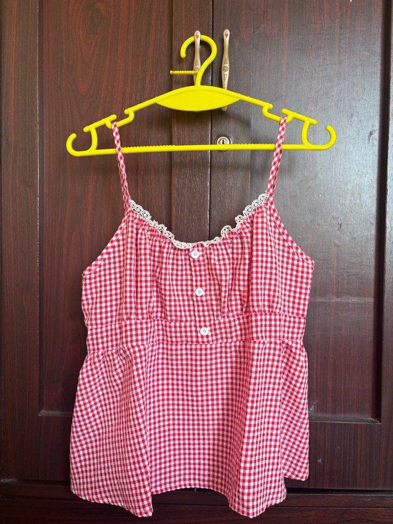 Red Gingham peplum top (Category: Sleeveless) located in Quezon City. Submitted by didcluttered (Listing ID 1416687566, Image 1). Description: :payment first via gcash/maya/bank transfer :shipping via jnt :sf shouldered by buyer - Red and white gingham pattern - Thin straps - Lace trim neckline - Button-up front - Gathered back - Cute and summery style.