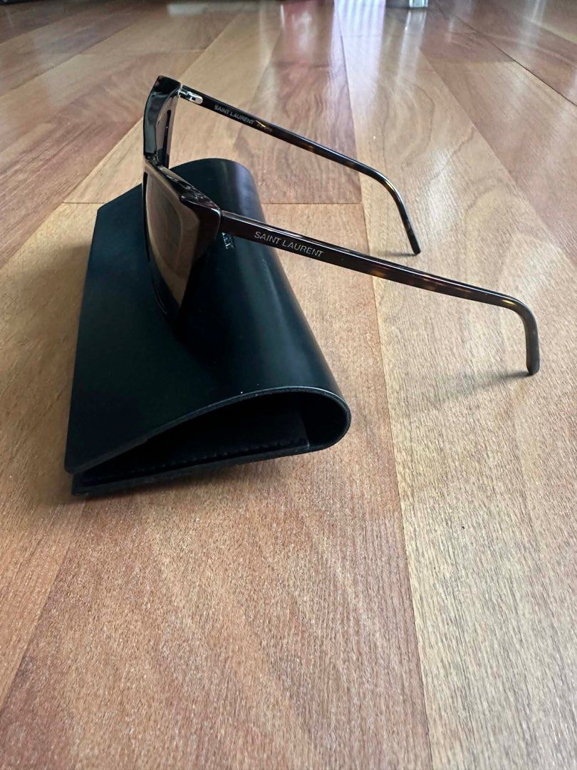 Saint Laurent Cat Eye Sunglasses (Category: Sunglasses & Eyewear) located in Paranaque City. Submitted by msurfer (Listing ID 1416723111, Image 2). Description: Authentic and brand new!!! - Saint Laurent cat-eye sunglasses - Dark tortoiseshell frame - Matching lenses - Comes with a black case - Saint Laurent logo on temples - Perfect for everyday wear.