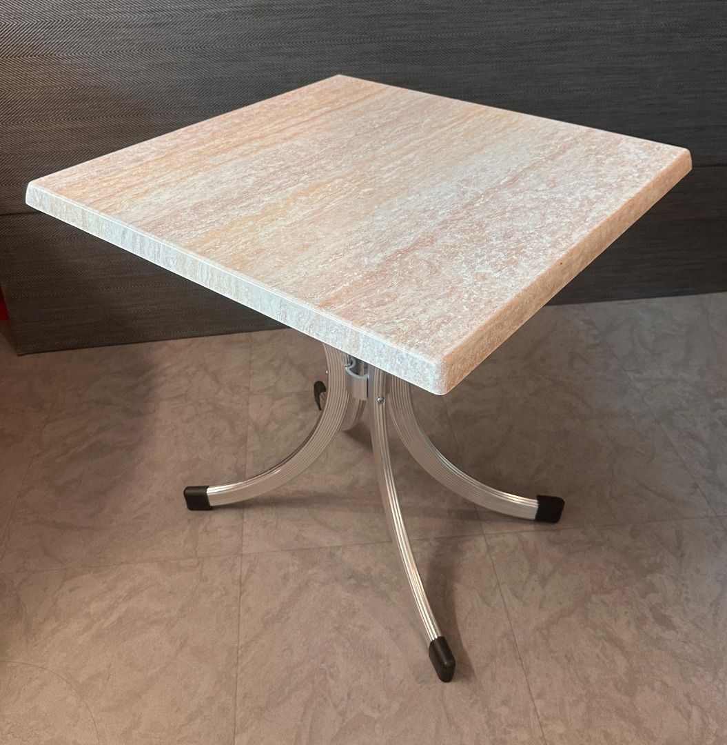 Solid PVC Beige Top Table (Category: Tables & Sets) located in Singapore. Submitted by decoexpressionsg (Listing ID 1416689136, Image 3). Description: Square table with a light beige stone-like top and elegant silver aluminium curved legs. The design is simple yet stylish, making it suitable for cafes, dining nooks, or patios. Sturdy construction with protective foot caps. Measurements (approx): Table Top length: 68.5cm Table Top width: 68.5cm Ta