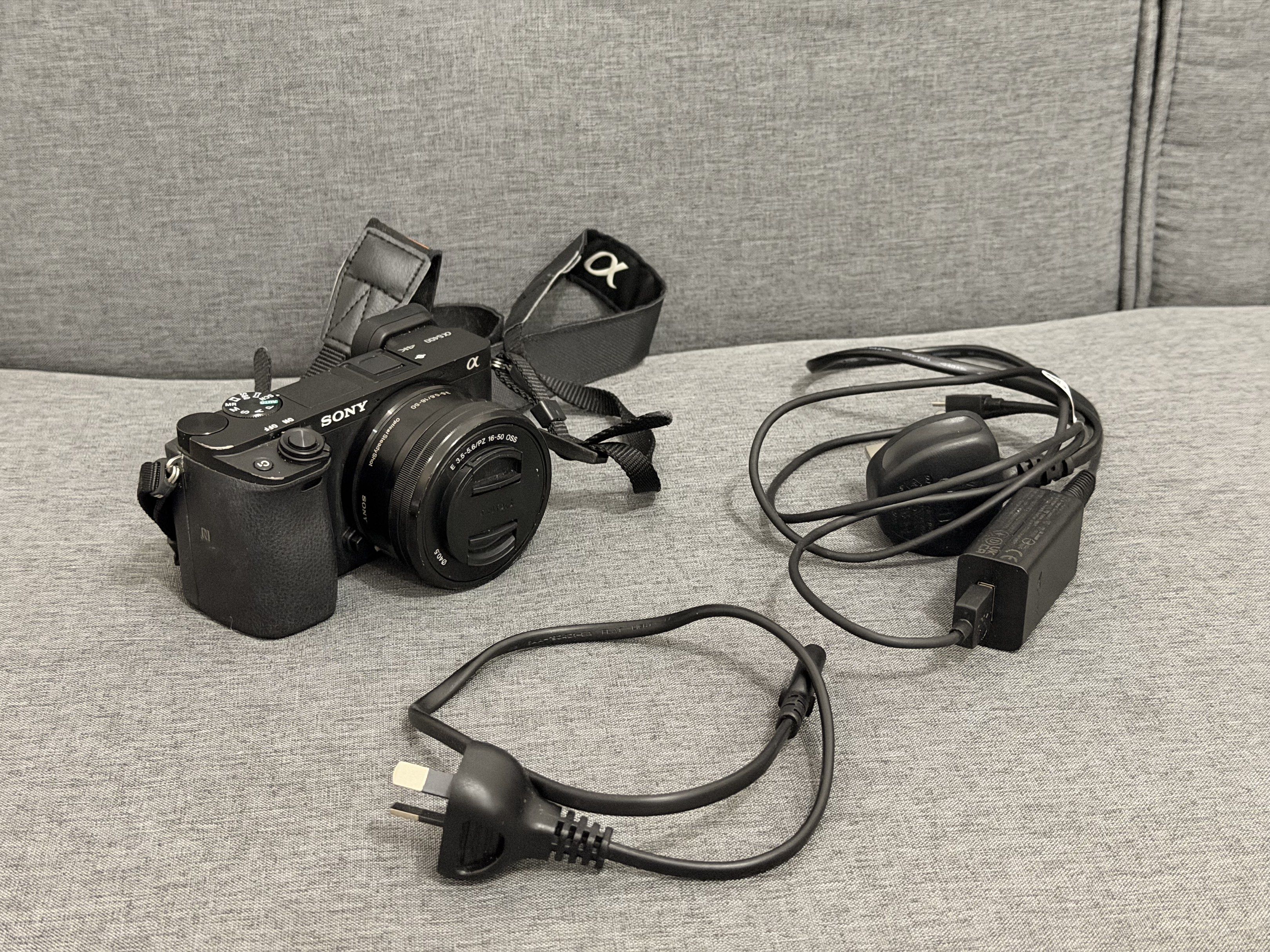 Sony Alpha a6400 Mirrorless Camera (Category: Cameras) located in Mandaluyong City. Submitted by empresskie (Listing ID 1416799386, Image 1). Description: - Sony Alpha a6400 mirrorless camera - Includes lens and strap - Comes with charger and power cable - Black camera body - Features screen and various buttons - Lens cap included - Sony Alpha branded strap.
