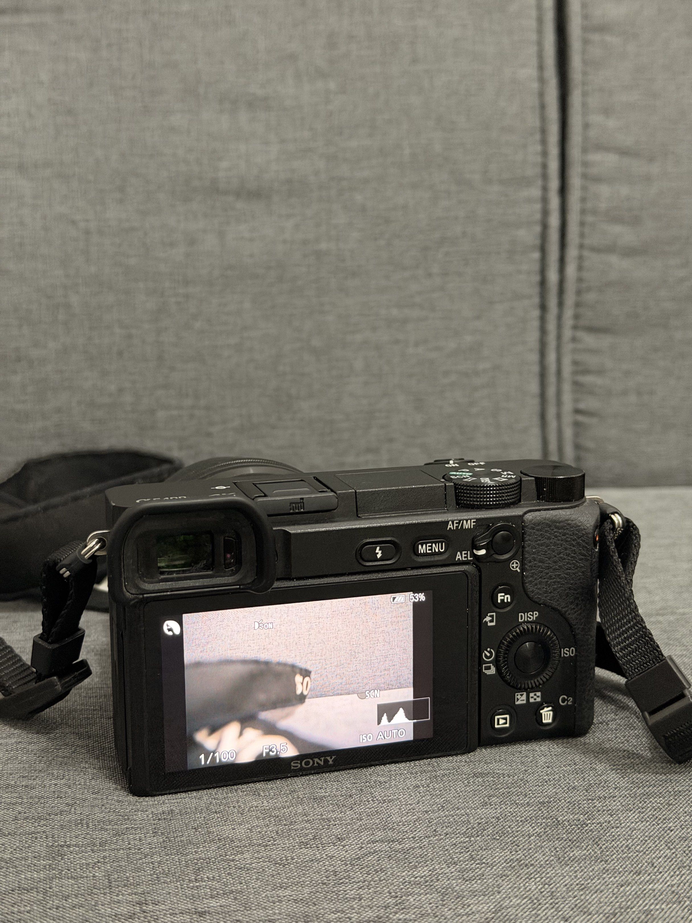 Sony Alpha a6400 Mirrorless Camera (Category: Cameras) located in Mandaluyong City. Submitted by empresskie (Listing ID 1416799386, Image 3). Description: - Sony Alpha a6400 mirrorless camera - Includes lens and strap - Comes with charger and power cable - Black camera body - Features screen and various buttons - Lens cap included - Sony Alpha branded strap.