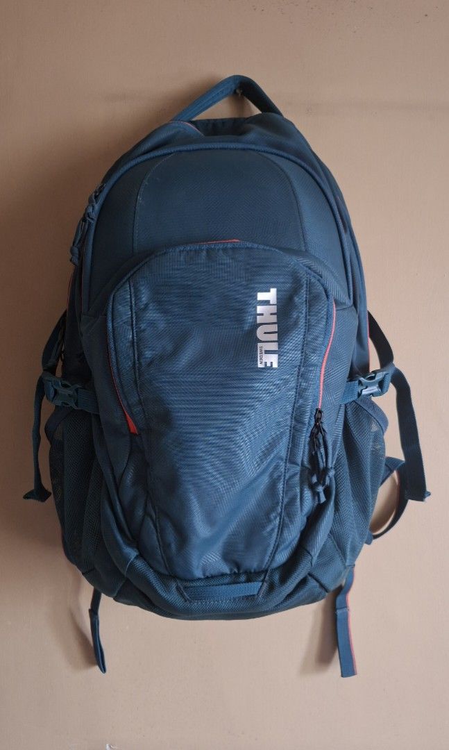 Thule Narrator Teal Backpack 31L (Category: Laptop Bags & Sleeves) located in Manila. Submitted by thrifter_lifestyle (Listing ID 1416668189, Image 1). Description: Brand: Thule Specs Style and Color: Thule Narrator Backpack 31L (Deep Teal Camo/Coral) Series : Narrator Bag volume: 31L Dimensions: 32 x 8 x 50 cm Laptop compartment: 38.5 x 26.5 x 3.1 cm Weight: 1 kg Material: Nylon (see tag) Barely used, good as new. Selling with original paperbag.