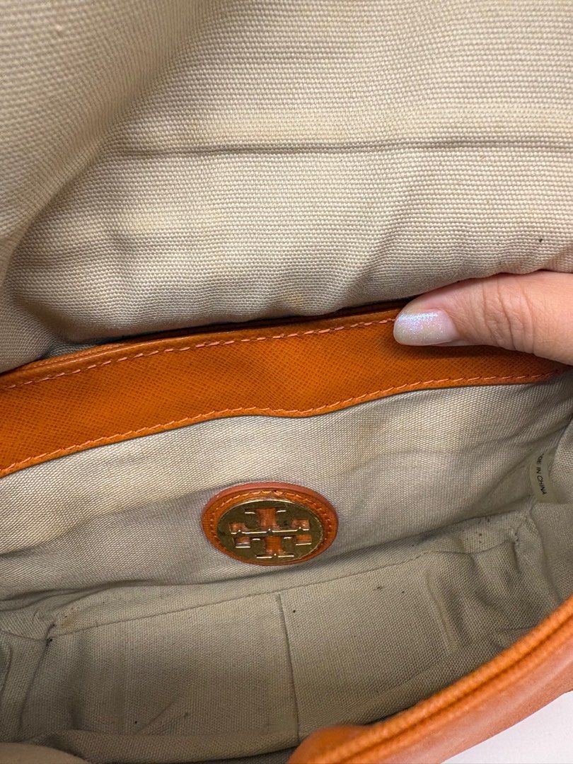 Tory Burch Robinson Chain Shoulder Bag (Category: Luxury Bags & Wallets) located in Makati City. Submitted by harekrisha (Listing ID 1416674541, Image 3). Description: Tory Burch Robinson crossbody bag in orange saffiano leather. Features a flap closure and heavy chain strap. Please manage expectations: the bag is slightly misshapen from storage and the chain shows minor wear, but the leather and exterior still look good and presentable. Just dec