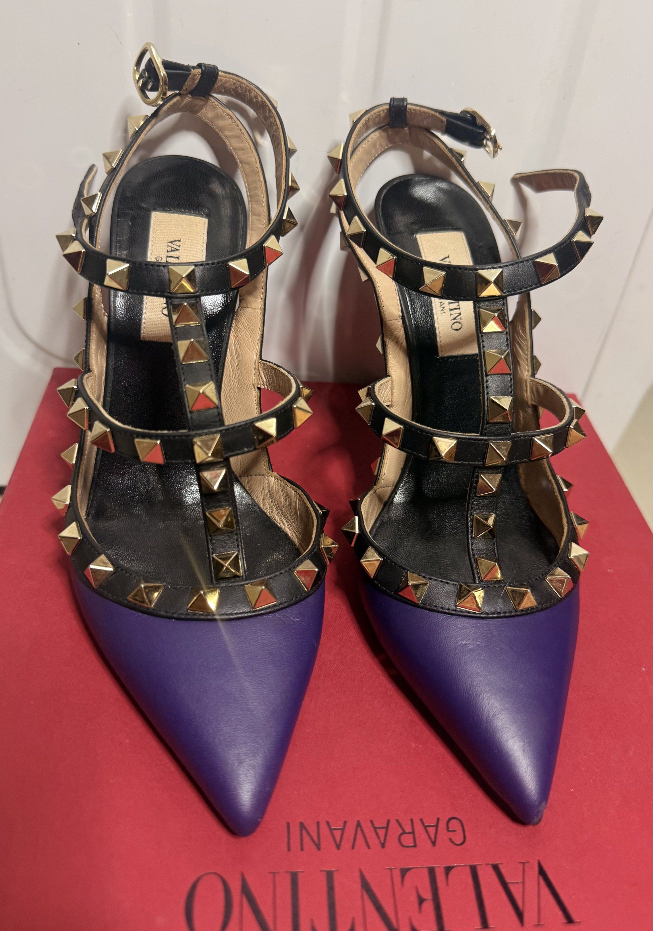 Valentino Garavani Rockstud Ankle Strap Heels (Category: Heels) located in Taguig. Submitted by aa_decluttering (Listing ID 1416661605, Image 2). Description: ‼️ PLEASE READ BEFORE INQUIRING ‼️ Kindly read the description carefully. Questions already answered will not be entertained. Valentino Garavani Rockstud Ankle Strap Heels Size: US 6 Color: Purple with black straps and gold-tone Rockstud hardware Heel Height: Approx. 10 cm (4 inches) Inclus