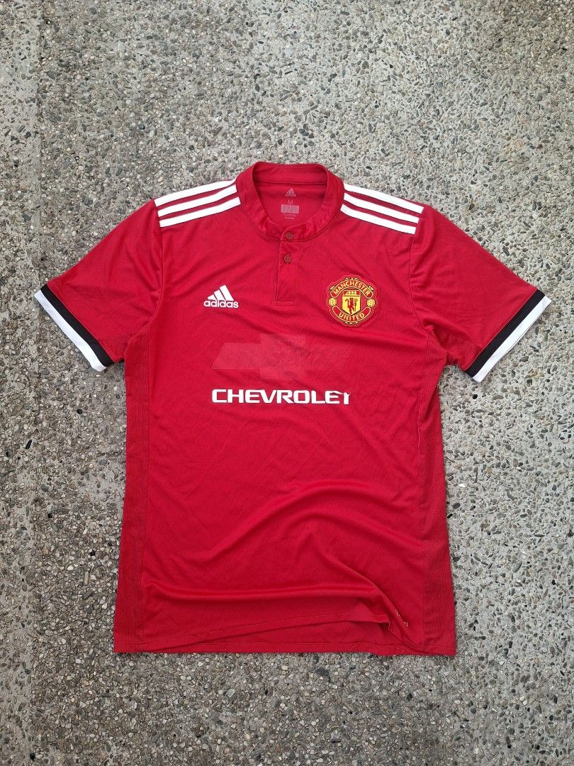 Adidas Manchester United Jersey (Category: Activewear) located in Marikina City. Submitted by 2nd_chancedrips (Listing ID 1416932836, Image 1). Description: Official Manchester United jersey in red with the Chevrolet logo. Features the Adidas logo and three stripes on the shoulders. The jersey has a collared neckline with two buttons. The tag indicates it is a Climacool jersey. Authentic m on tag 20 x 28 excellent condition embroidered logo issue