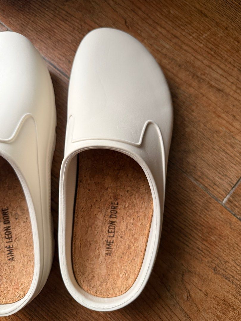 Aime Leon Dore - Garden Mule White Slip Ons (Category: Slippers and slides) located in Quezon City. Submitted by jong_17 (Listing ID 1416838284, Image 3). Description: Aime Leon Dore - Garden Mule White Slip Ons Aime Leon Dore White garden mule with Embossed logo at heel & outsole, Laser etched logo at footbed and Removable cork footbed. RFS: wrong size Retails at $95.