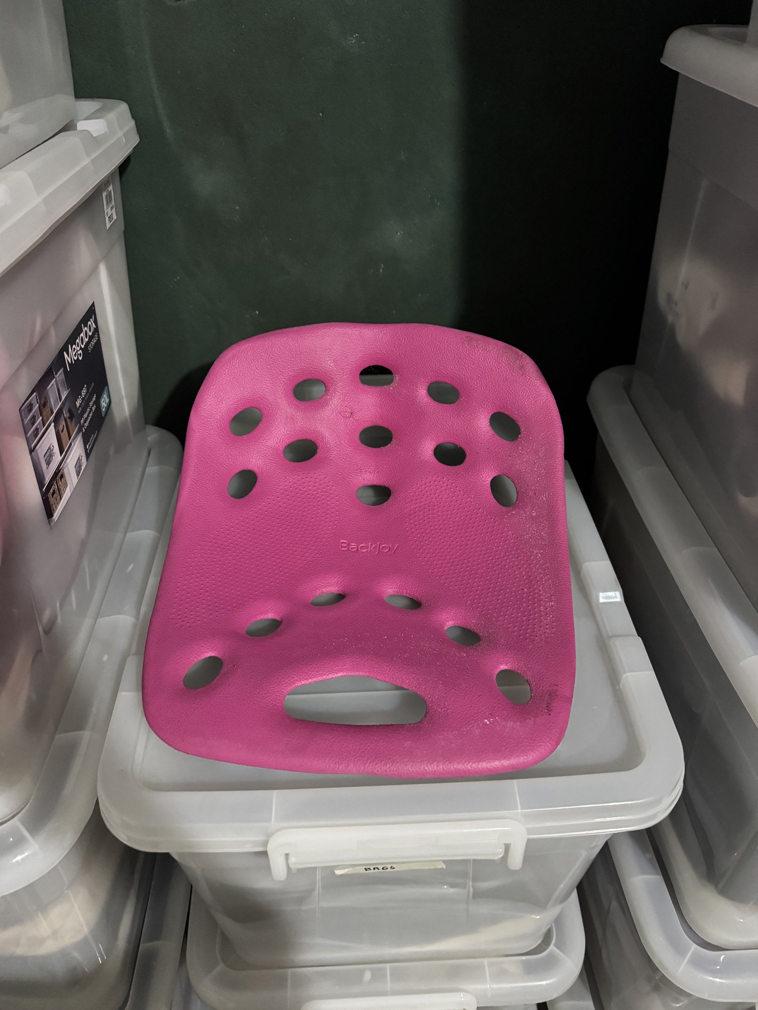 BackJoy Posture Support (Category: Braces, Support & Protection) located in Quezon City. Submitted by myprelauved (Listing ID 1416989805, Image 1). Description: - BackJoy posture support - Pink and black design - Improves posture while sitting - Features ventilation holes - Curved shape for support - Includes a handle for easy carrying - BackJoy logo visible.