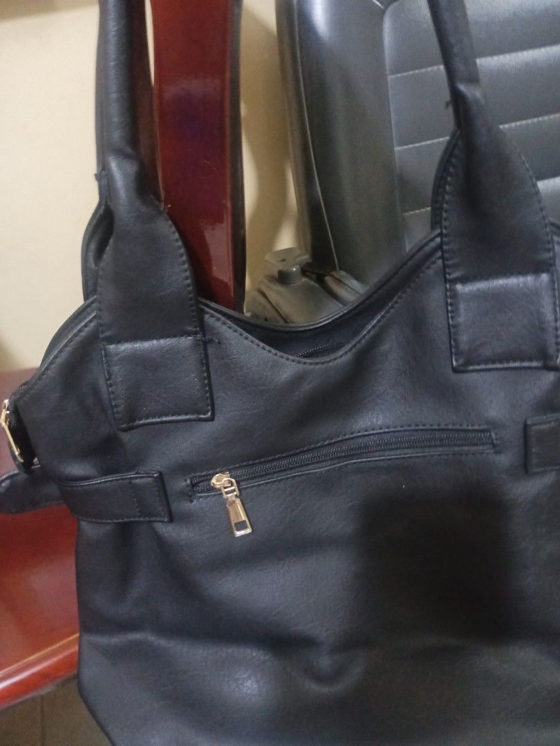 Black Handbag with Gold Accents (Category: Luxury Bags & Wallets) located in Bacoor. Submitted by mms123mms (Listing ID 1416904558, Image 2). Description: - Black handbag - Gold-colored buckle details - Double handles and shoulder strap - Zippered pocket (back and inside) - Lined interior - Structured shape - Faux leather material.