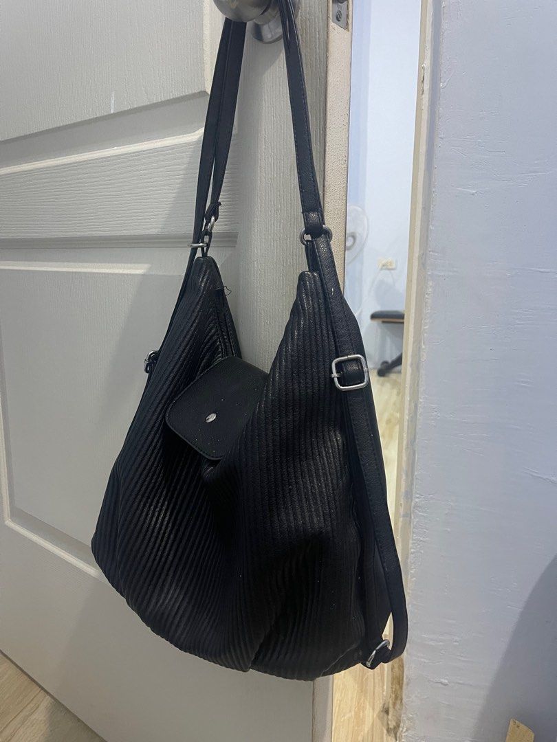 Black Hobo Bag with Shoulder Strap (Category: Shoulder Bags) located in Quezon City. Submitted by kmalaza (Listing ID 1416986004, Image 2). Description: - Stylish black hobo bag - Unique textured design - Flap closure with single button - Includes shoulder strap - Spacious interior - Suitable for everyday use - Sleek, modern design.