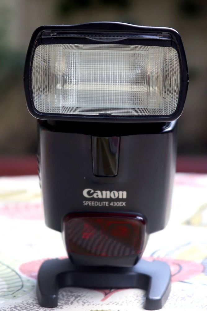 Canon Speedlite 430EX Flash (Category: Flashes) located in Quezon City. Submitted by jose.verzosa (Listing ID 1416895887, Image 2). Description: - Canon Speedlite 430EX flash unit - Includes flash, instruction manual, and protective case - Features a digital display - Tiltable flash head - Black color.