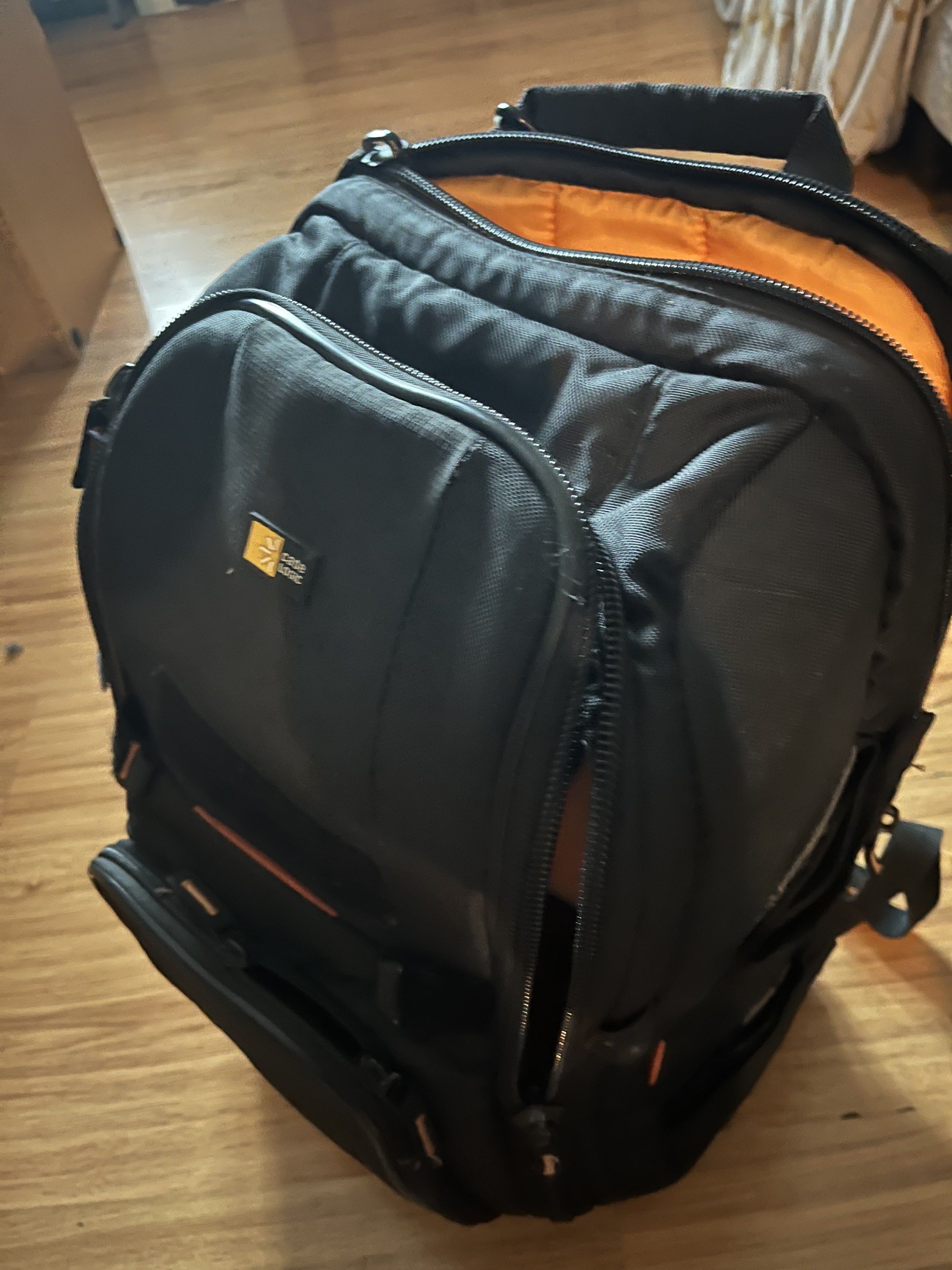 Case Logic Camera Backpack (Category: Camera Bags & Carriers) located in Pasig City. Submitted by wilsonwill38327 (Listing ID 1416887269, Image 1). Description: - Black Case Logic camera backpack - Multiple compartments and orange interior - Padded back and adjustable straps for comfort - Includes dividers and padded inserts for camera gear - Front and side pockets for accessories This is a used item but still functional and still in pleasant con