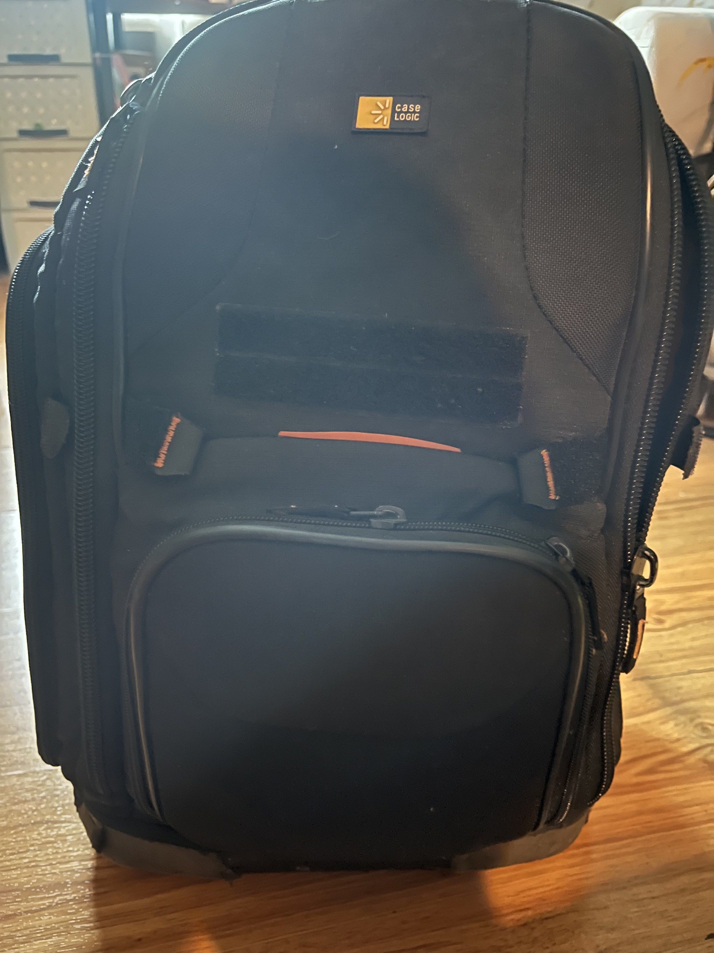 Case Logic Camera Backpack (Category: Camera Bags & Carriers) located in Pasig City. Submitted by wilsonwill38327 (Listing ID 1416887269, Image 2). Description: - Black Case Logic camera backpack - Multiple compartments and orange interior - Padded back and adjustable straps for comfort - Includes dividers and padded inserts for camera gear - Front and side pockets for accessories This is a used item but still functional and still in pleasant con