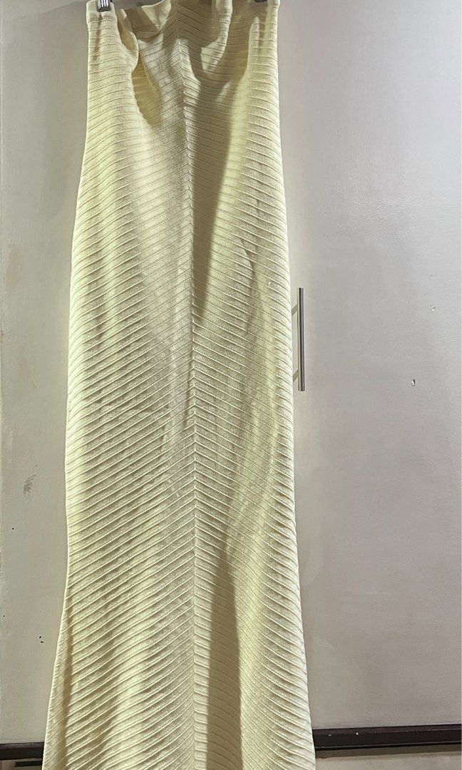 Cream Halter Neck Maxi Dress (Category: Dresses) located in Manila. Submitted by baddxss (Listing ID 1416913407, Image 3). Description: *actual when worn photos Elegant cream-colored maxi dress. Features a halter neck design and a form-fitting silhouette that flows down to the floor. The dress has a unique textured knit pattern..