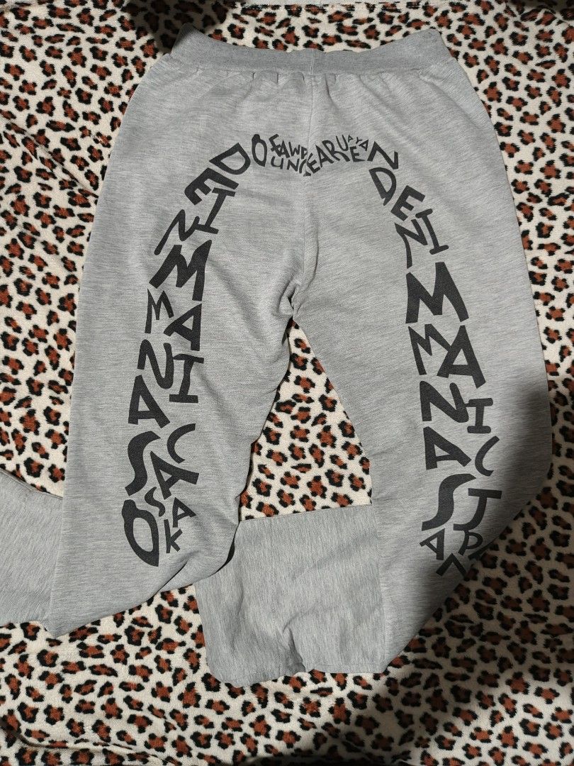 EVISU Grey Sweatpants (Category: Joggers) located in Cavite. Submitted by lestergal83399 (Listing ID 1416905284, Image 1). Description: - EVISU Grey Sweatpants - Size: XL - Relaxed Fit - Drawstring Waist - Small front logo - Large graphic on back leg - Pockets.