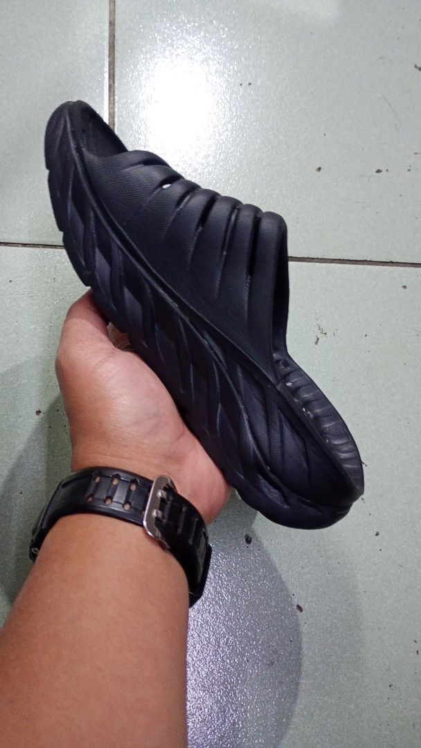 Hoka One One Black Sandals(23 cm) (Category: Flats & Sandals) located in Baguio. Submitted by brand_master (Listing ID 1416968271, Image 2). Description: Authentic Hoka One One Women's ORA Recovery Slide 2(6 US L) - Black - Slip-on design for easy wear - Features a textured footbed for grip - Thick, cushioned sole for comfort - Durable synthetic material - Hoka One One logo visible Thick outsole Minimal sign of usage In excellent condition .