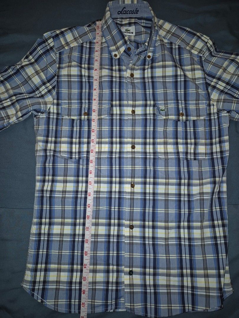 Lacoste Plaid Long Sleeve Shirt (Category: Tshirts & Polo Shirts ) located in Muntinlupa City. Submitted by matthewdavemanuel (Listing ID 1416946653, Image 3). Description: Authentic Lacoste long sleeve shirt Classic plaid pattern Button-down front Two chest pockets Embroidered Lacoste logo Color scheme: Blue, white, and navy Sizw 38 on Tag. Measurements are 18.5 inches width and 27.5 inches length.