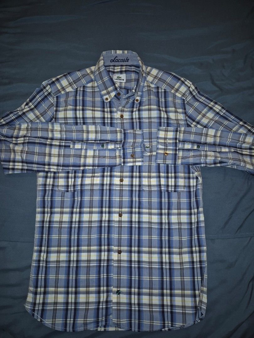 Lacoste Plaid Long Sleeve Shirt (Category: Tshirts & Polo Shirts ) located in Muntinlupa City. Submitted by matthewdavemanuel (Listing ID 1416946653, Image 1). Description: Authentic Lacoste long sleeve shirt Classic plaid pattern Button-down front Two chest pockets Embroidered Lacoste logo Color scheme: Blue, white, and navy Sizw 38 on Tag. Measurements are 18.5 inches width and 27.5 inches length.