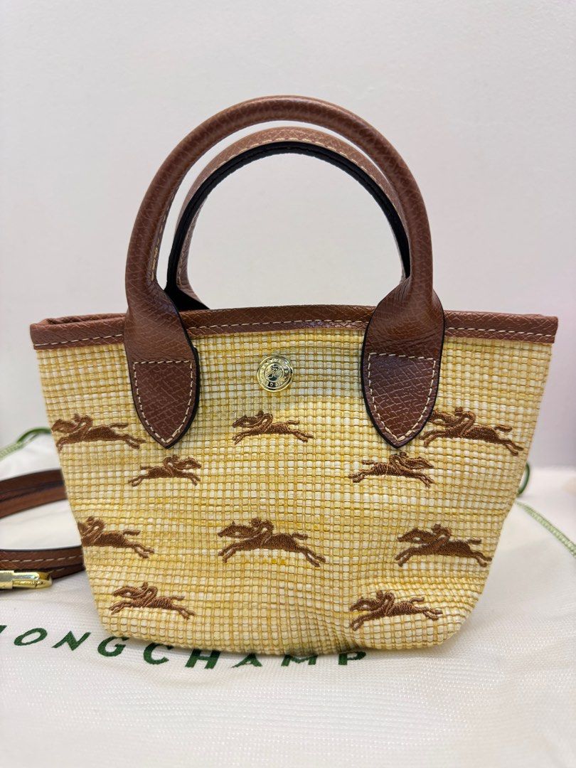 Longchamp Le Pliage Cuir Mini Tote Bag (Category: Luxury Bags & Wallets) located in Cabanatuan. Submitted by thearchivemuse (Listing ID 1416962117, Image 3). Description: - Longchamp Le Pliage Cuir Mini Tote Bag - Woven straw-like material with horse pattern - Brown leather handles and trim - Detachable shoulder strap - Includes Longchamp dust bag - Compact size, perfect for everyday use ORIG PRICE: ₱ 8,000.00.