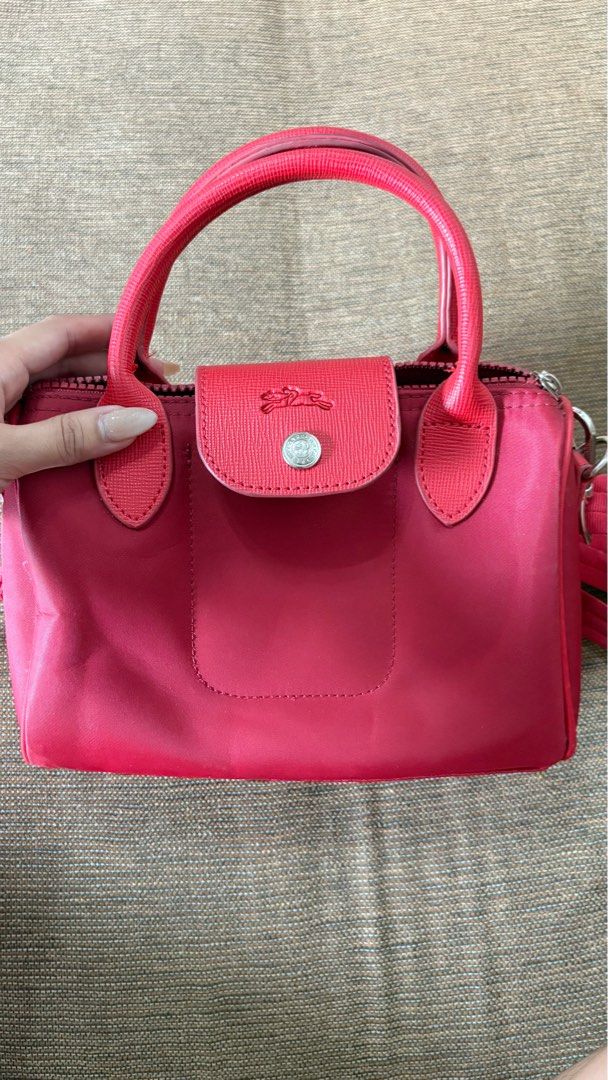 Longchamp Roseau Top Handle Bag (Category: Luxury Bags & Wallets) located in Batangas. Submitted by rndm.bits (Listing ID 1416990260, Image 2). Description: - Longchamp Roseau handbag - Color: Red - Features: - Top handle - Detachable shoulder strap - Flap closure with silver-tone button - Condition: Good RFS: Declutterring .