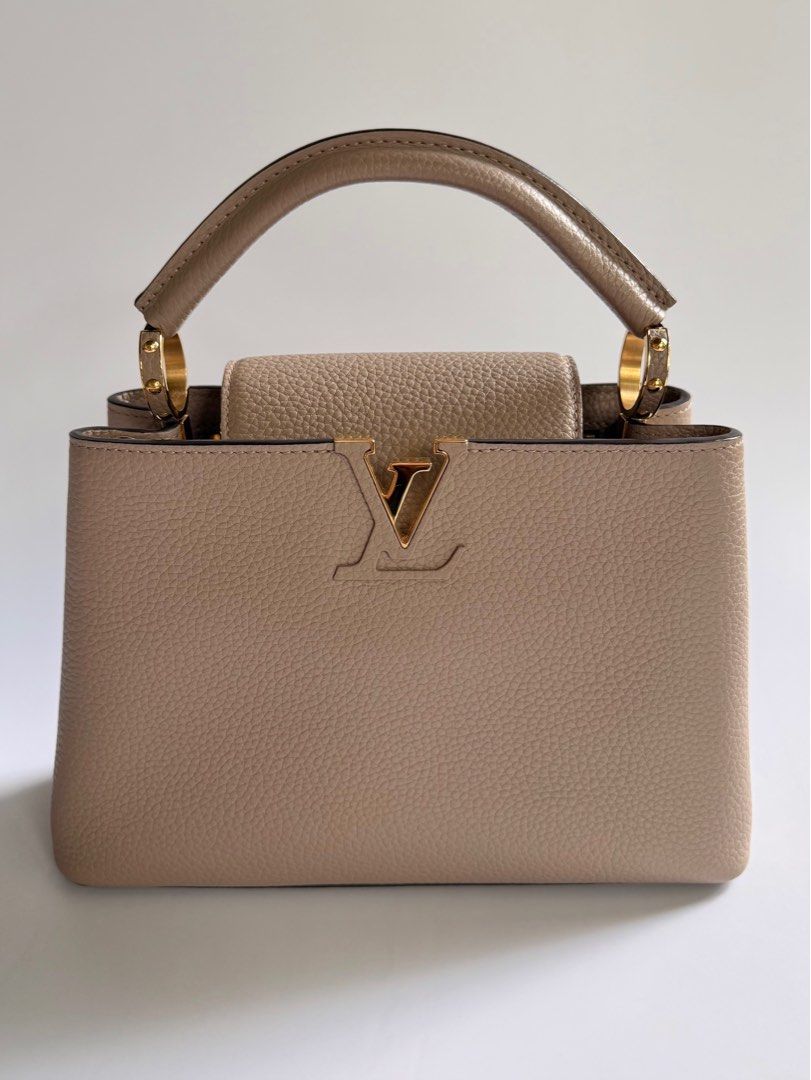 Louis Vuitton Capucines BB in Galet (Category: Luxury Bags & Wallets) located in Quezon City. Submitted by lian_closet (Listing ID 1416904600, Image 2). Description: Louis Vuitton Capucines BB in Galet Best Price: ₱150,000 Preloved Comes with Detachable Leather Strap, Dust Bags & Entrupy Certificate of Authenticity Preloved Rating: 9.5/10 Excellent Minimal hairline scratches on hardware Small crack on the piping No rubs on corners Interior is cle
