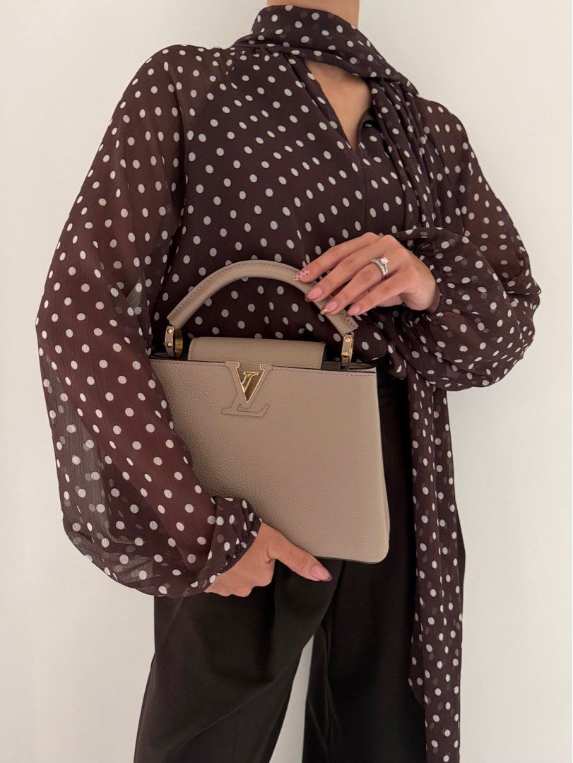 Louis Vuitton Capucines BB in Galet (Category: Luxury Bags & Wallets) located in Quezon City. Submitted by lian_closet (Listing ID 1416904600, Image 1). Description: Louis Vuitton Capucines BB in Galet Best Price: ₱150,000 Preloved Comes with Detachable Leather Strap, Dust Bags & Entrupy Certificate of Authenticity Preloved Rating: 9.5/10 Excellent Minimal hairline scratches on hardware Small crack on the piping No rubs on corners Interior is cle