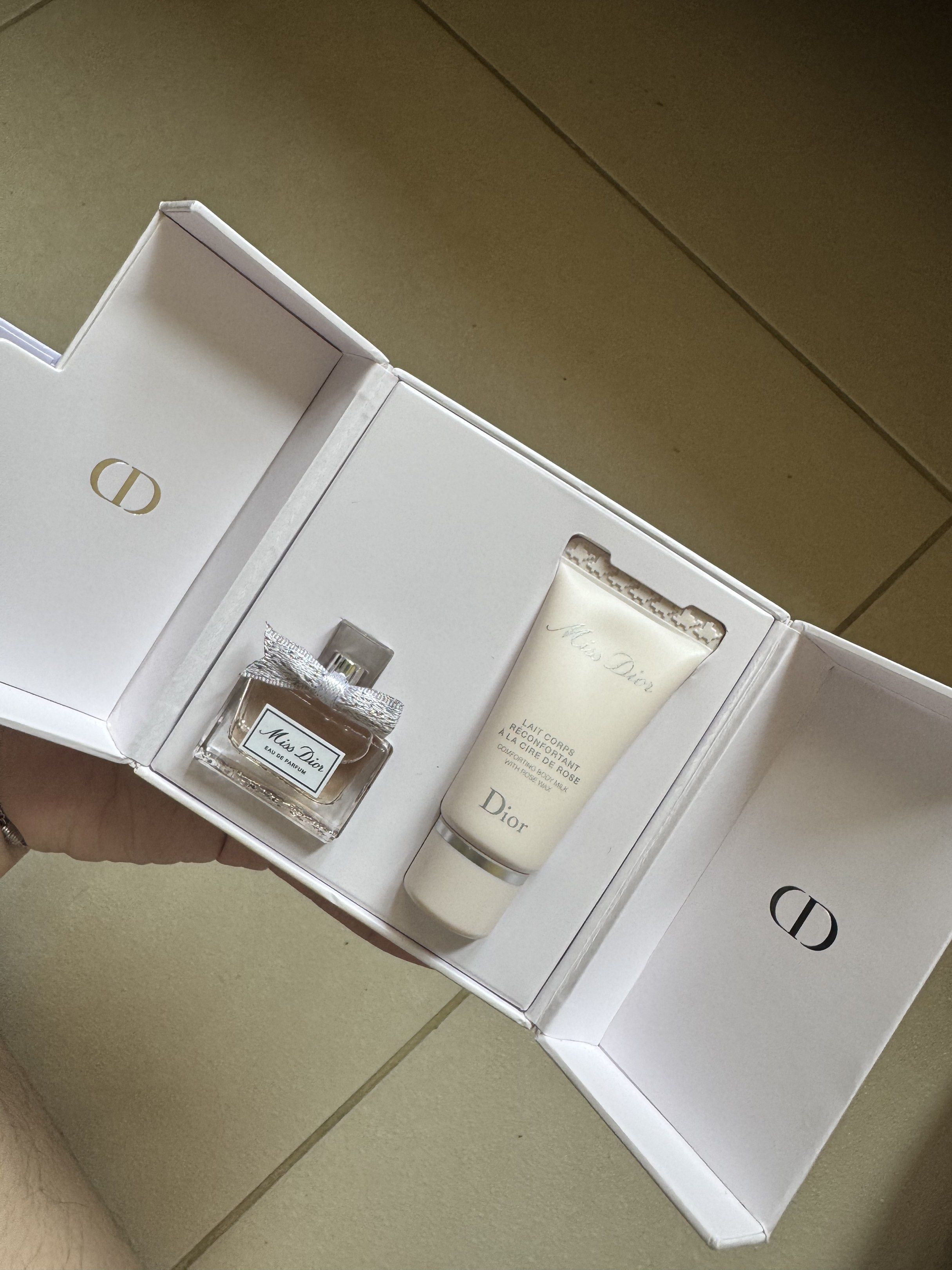 Miss Dior Eau de Parfum mini Set (Category: Fragrance & Deodorants) located in Pasay City. Submitted by sakusakusaku18 (Listing ID 1416847658, Image 2). Description: - Authentic Miss Dior set - Includes Eau de Parfum and body milk with rose wax - Comes in a white box - Features the Miss Dior logo - Perfume bottle adorned with a ribbon.